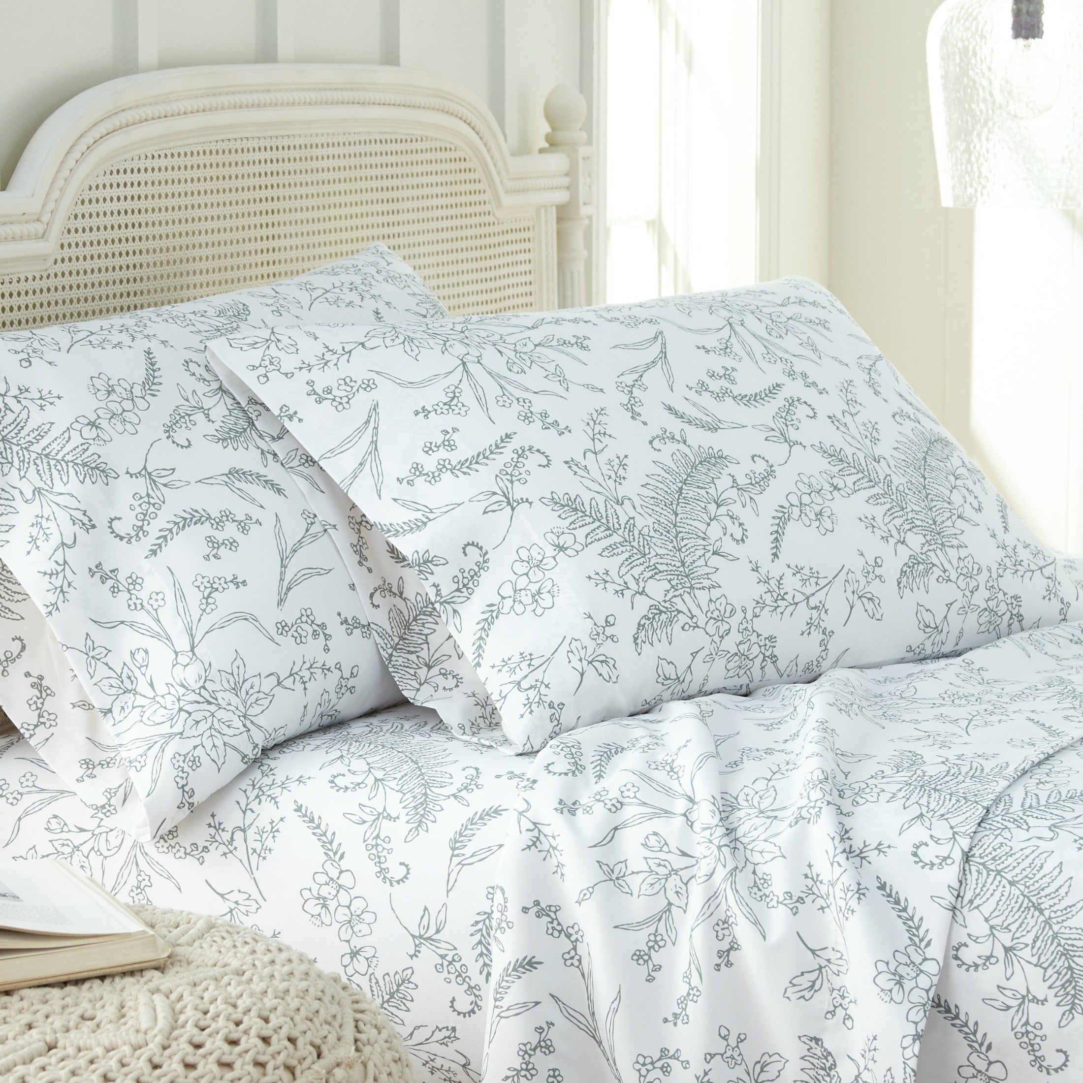 Angled View of Winter Brush Pillow Cases in White and Teal Flowers#color_winter-brush-white-with-teal-flowers