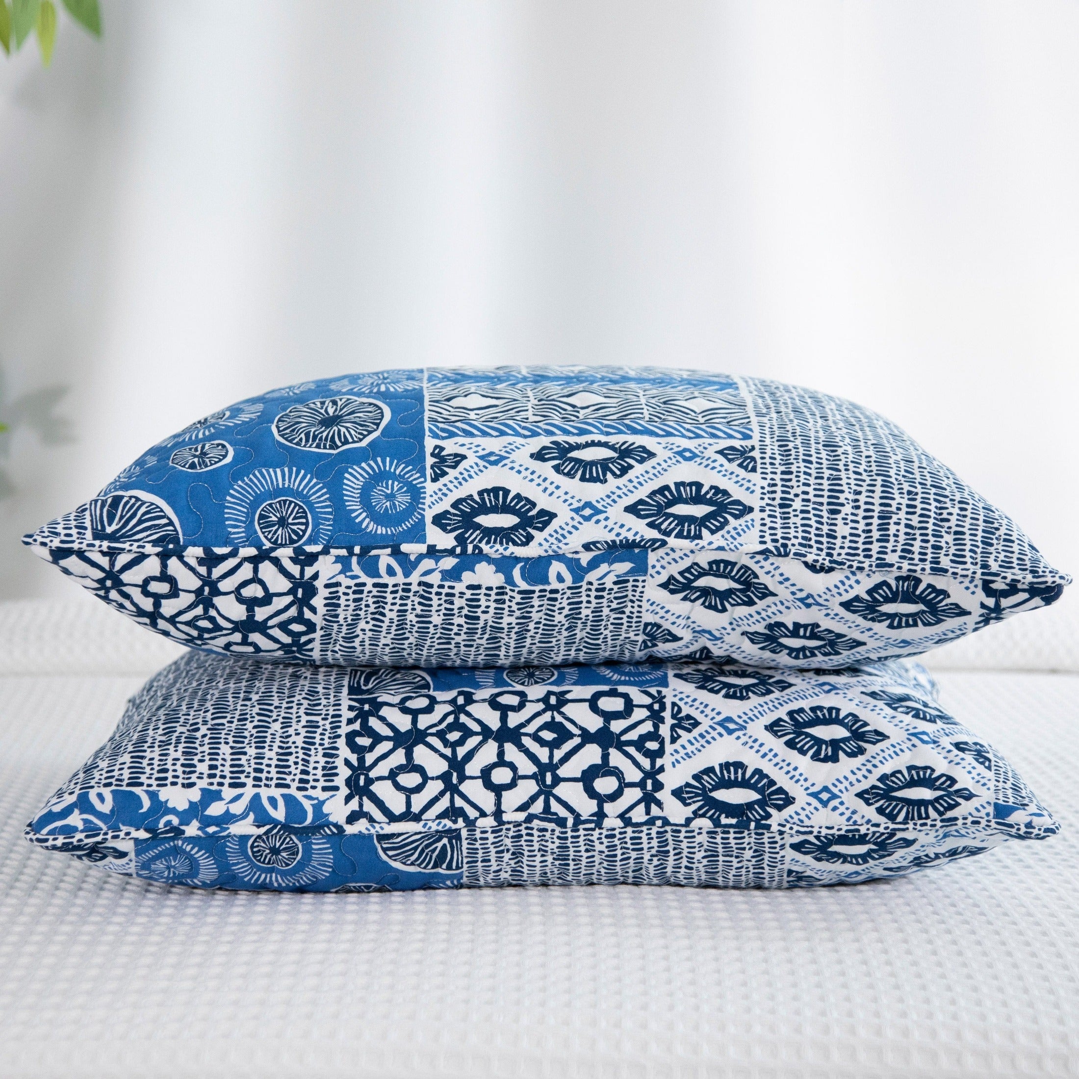 Global Patch Quilted Sham Covers Stack Together in Blue#color_global-patch-blue