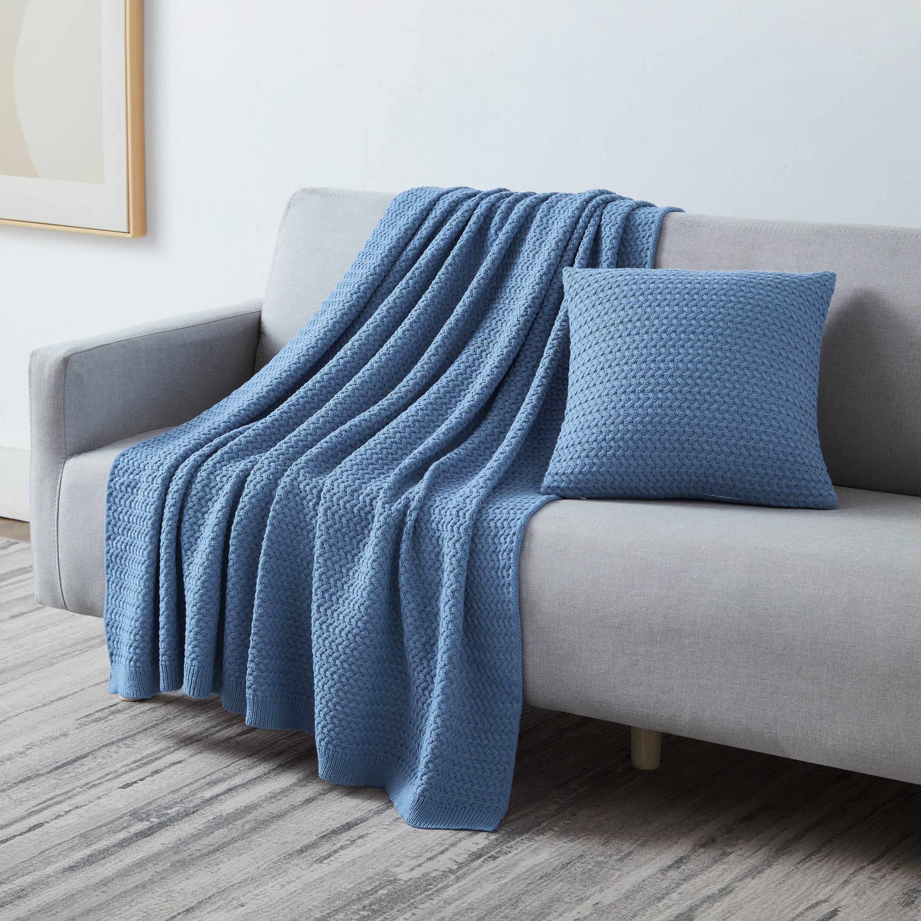 Angled View of Arcylic Throw Set in Blue on Sofa#color_acrylic-blue