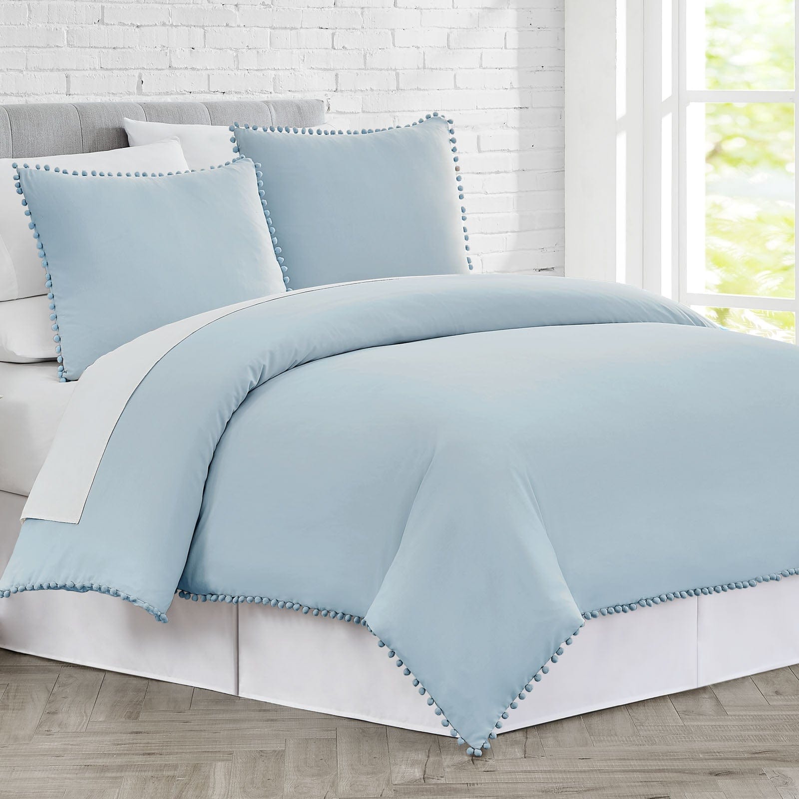 Side View of Pom-Pom Duvet Cover Set in Light Blue#color_light-blue