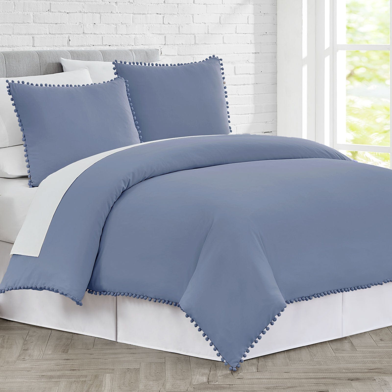 Side View of Pom-Pom Duvet Cover Set in Steel Blue#color_steel-blue