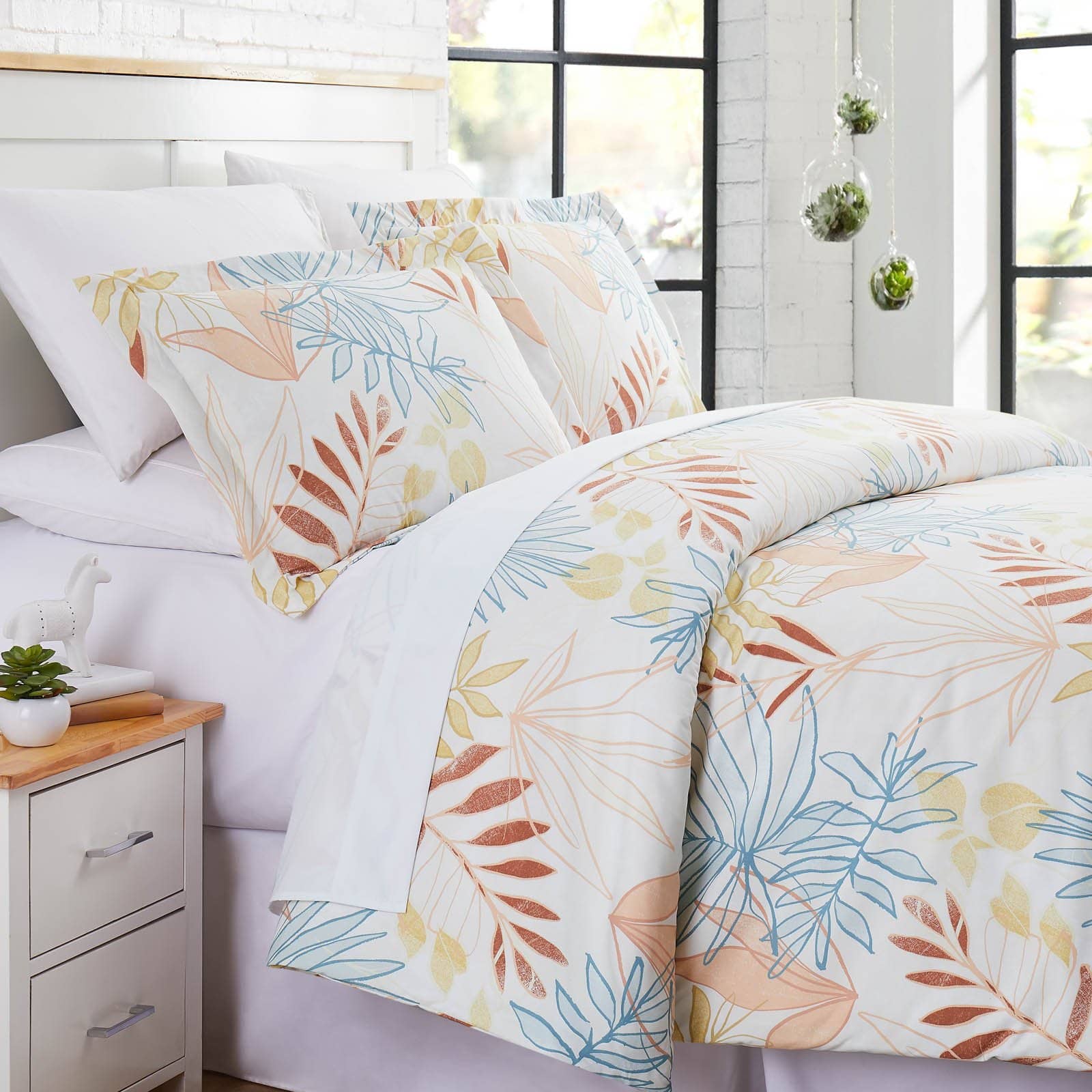 Angled View of Tropic Leaf Duvet Cover Set in cream#color_tropic-leaf-cream