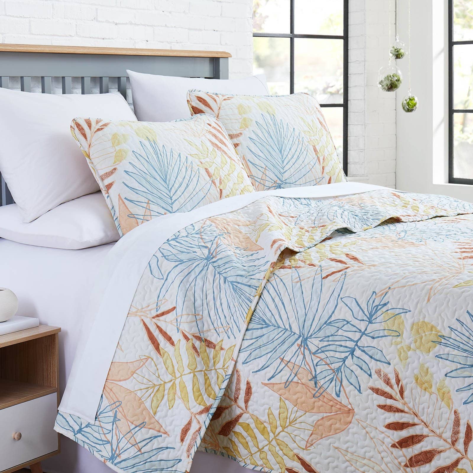 Angled View of Tropic Leaf Oversized Quilt Set in Cream#color_tropic-leaf-cream