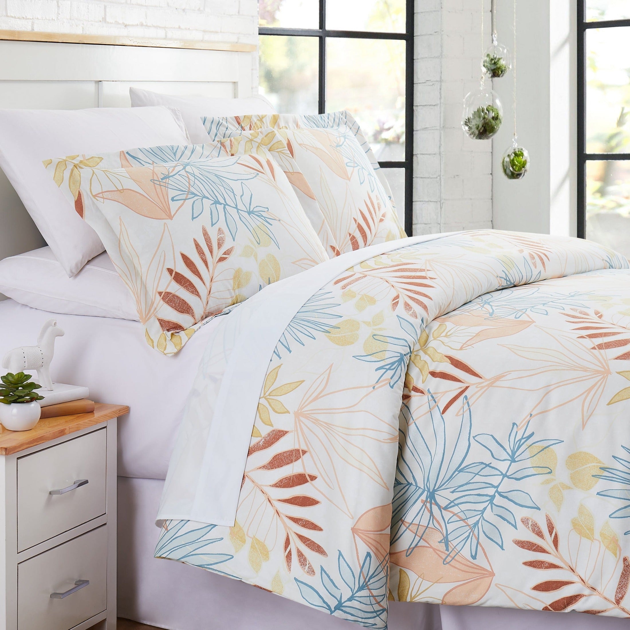Angled View of Tropic Leaf Comforter Set in Cream#color_tropic-leaf-cream