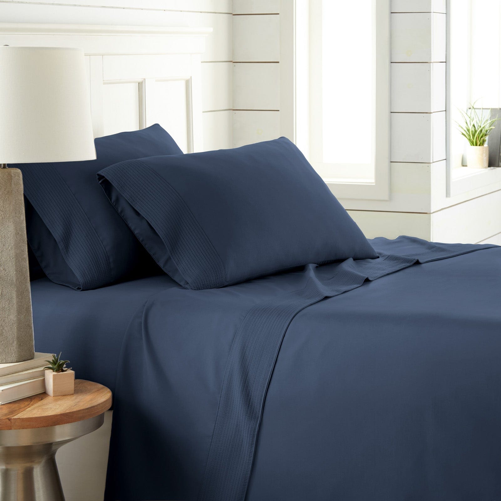 Side View of Vilano Extra Deep Pocket Pleated Sheet Set in Dark Blue#color_vilano-dark-blue