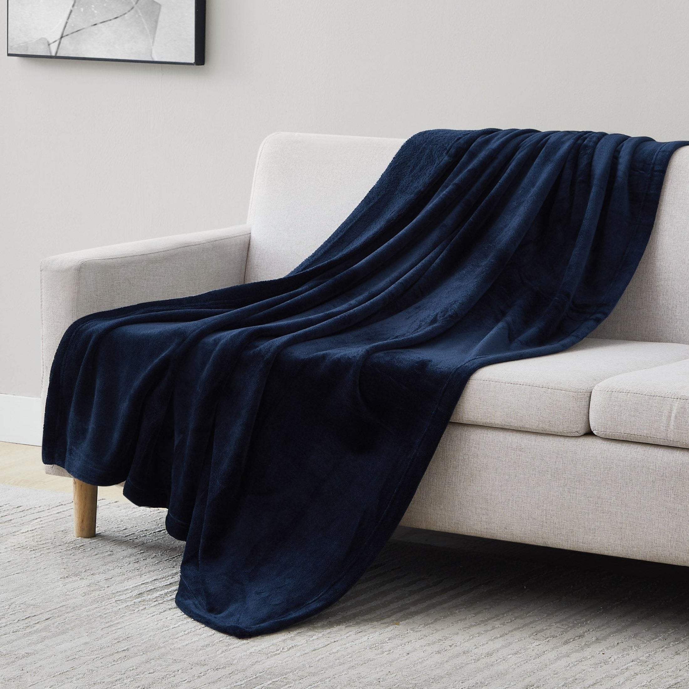 Microfleece Oversized Blankets and Throws in Navy Blue on Sofa#color_microfleece-navy-blue