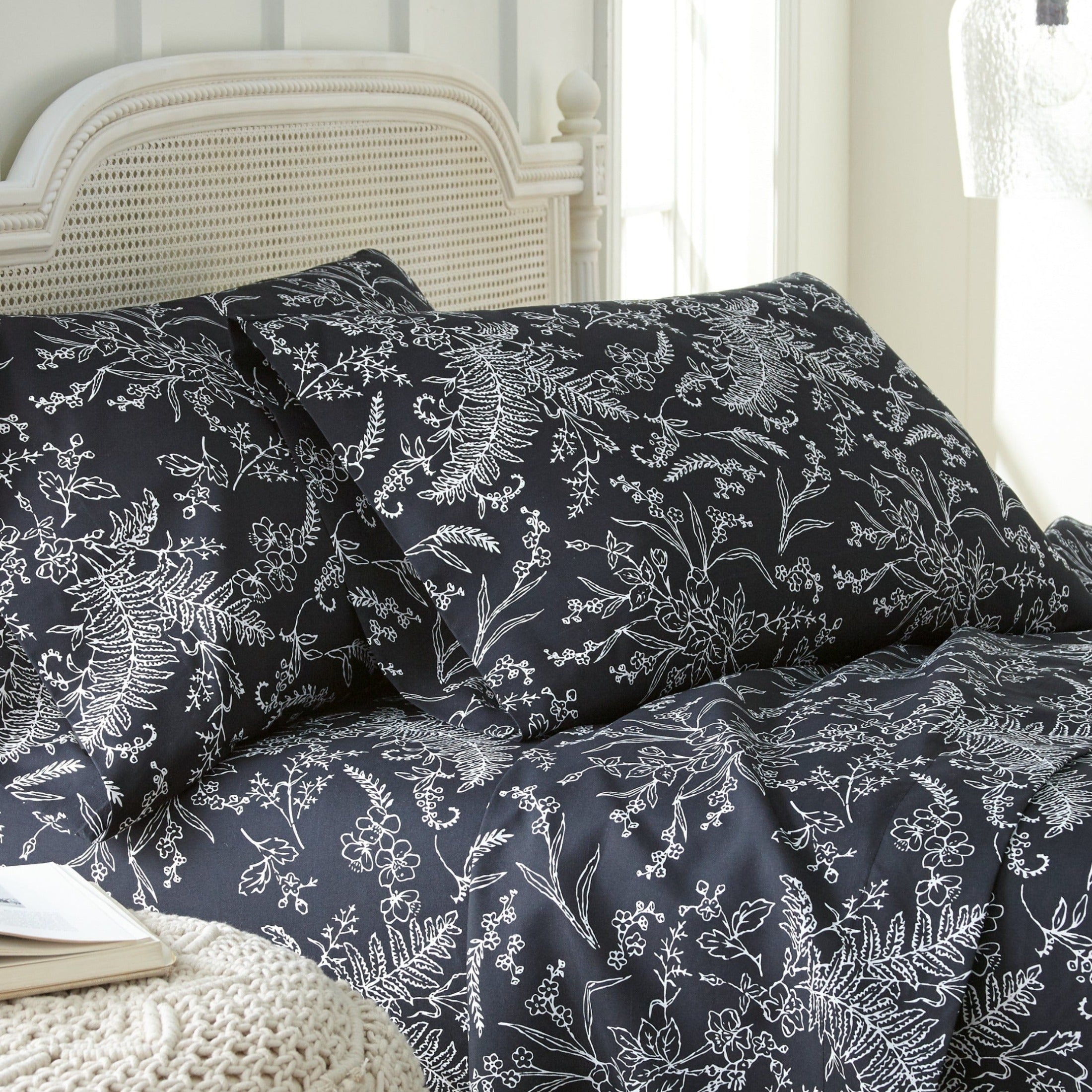 Side View of Winter Brush Pillow Cases in Black and White#color_winter-brush-black-with-white-flowers